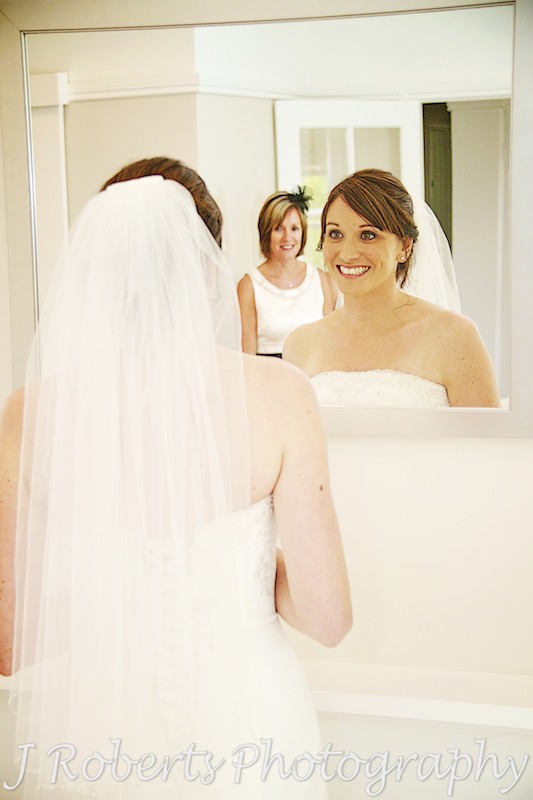 bride looking at herself in the mirror - wedding photography sydney